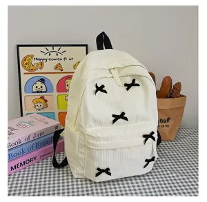 Japanese style corduroy backpack with black bow appliques for daily school use and travel.
