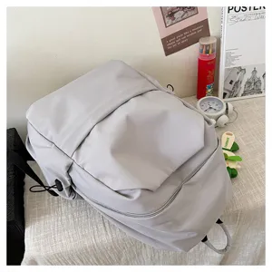 Minimalist solid color large capacity casual backpack for students and daily commuting.