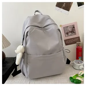 Casual solid color large capacity school backpack for daily travel and student use.