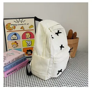 White corduroy backpack for women, cute black bow aesthetic school bag for daily use.