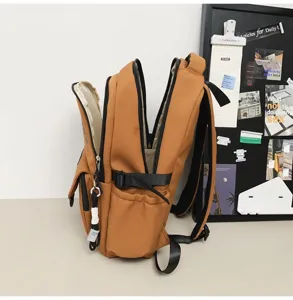 Detailed side view of retro brown multi-compartment student backpack with spacious design.