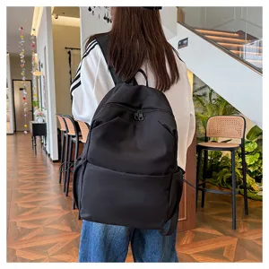 Casual black backpack for women and men, large capacity solid color school bag for daily commute.