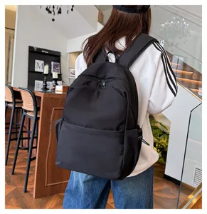 Detailed view of the solid black casual backpack featuring durable fabric and ample space.