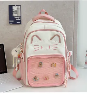 Detailed shot of the cute pink cat ear backpack featuring a front mesh pocket and lovely charms.