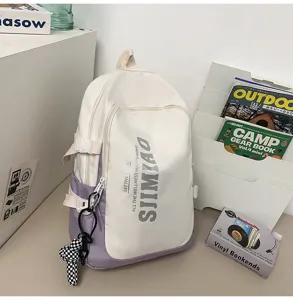 Detailed view of large capacity student backpack with dual tone white and purple design.