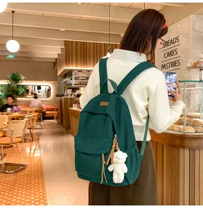 Detailed view of large capacity dark green corduroy backpack for teenage girls school and travel.