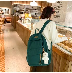 Dark green corduroy backpack with cute bear pendant, large capacity casual daypack for school.