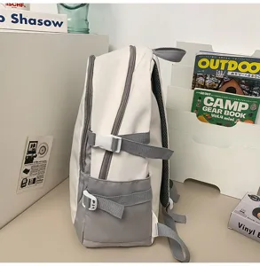 Side detail view of the white and grey casual backpack with buckle straps and side pocket.