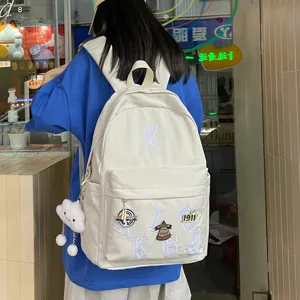 American style minimalist large capacity white backpack with letter embroidery and pendant.