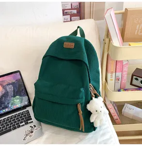 Large capacity green corduroy school backpack for teen girls, stylish daily travel bag with charm.
