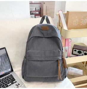 Casual corduroy backpack with large capacity and multi pockets for students daily travel detailing.