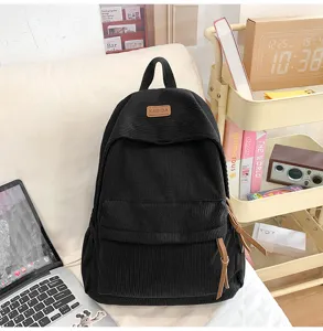Black corduroy backpack detail view, large capacity school bag for daily travel and school use.