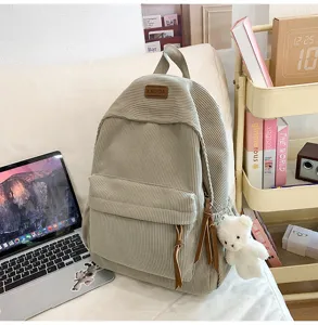 Corduroy casual backpack with front pocket and cute bear pendant, large capacity school bag.
