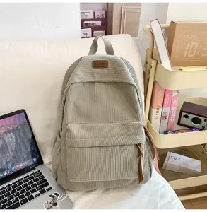 Corduroy backpack detail, casual large capacity school bag with front pocket and label patch.