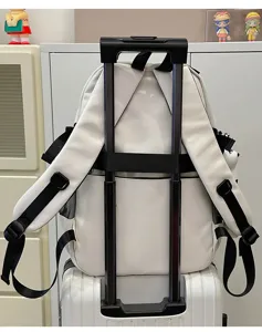 Utility style white backpack with luggage strap, large capacity school bag for students.