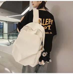 Minimalist large capacity white canvas backpack detail shot, perfect for daily casual use.