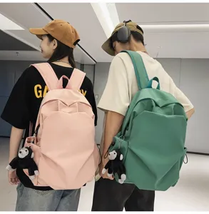 Minimalist large capacity canvas school backpack with cute monkey pendant for college students.
