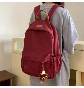 Detailed view of casual korean style school backpack with cute pendant, everyday campus carry.