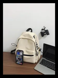 Minimalist solid color backpack detail showcasing clean white fabric and side pocket design.