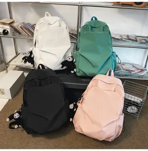 Large capacity casual canvas school backpack with cute monkey pendant for daily use and travel.