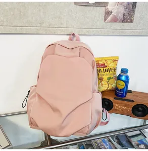 Minimalist pink casual backpack for daily use, large capacity school bag with stylish design.