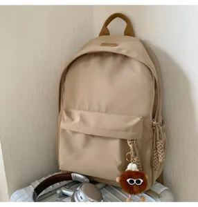 Korean style minimalist student backpack detail showcasing cute pendant and design.