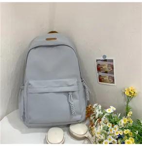 Casual light grey backpack for school students, minimalist travel daypack with front pocket.