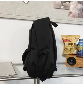 Minimalist black backpack detail, large capacity student casual daypack, daily use school bag.