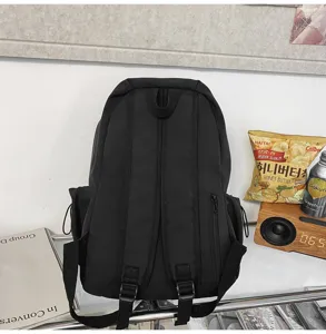 Classic black minimalist canvas backpack, large capacity school bag for daily commute and casual use.