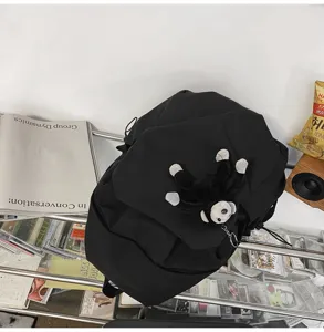 Black casual backpack with cute monkey pendant, minimalist harajuku style daily bag.