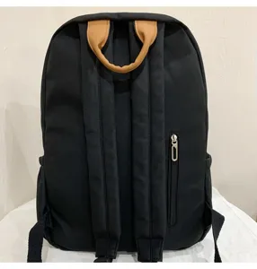 Classic black canvas school backpack with brown top handle, comfortable straps and back zipper pocket.