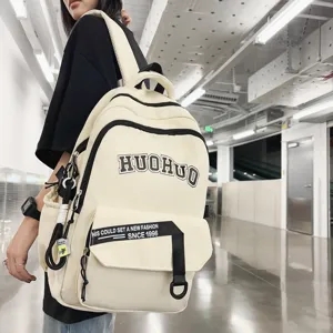 Beige canvas backpack with letter print, large capacity school bag for daily use.
