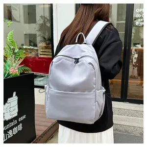 Detail view of the casual solid color large capacity backpack, showing side pocket design.