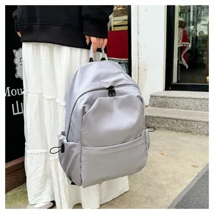 Casual grey backpack detail showing large capacity, multiple pockets, and durable fabric for daily use.