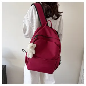 Casual wine red backpack for women, large capacity school bag with cute white bear pendant.