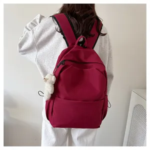 Solid color large capacity casual backpack school bag detail view showing comfortable wear and style.