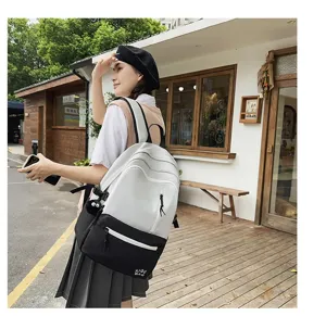 Contrast color student backpack for women, stylish campus casual laptop bag detail view.