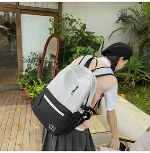 Contrast color school backpack for women, stylish two-tone campus book bag with ample storage.