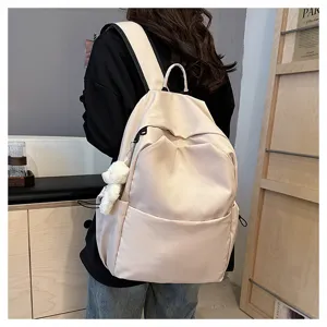 Casual beige backpack detail view, large capacity school bookbag with cute plush pendant and pockets.