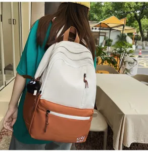 Colorblock casual backpack for women and students with large capacity and cute plush pendant.