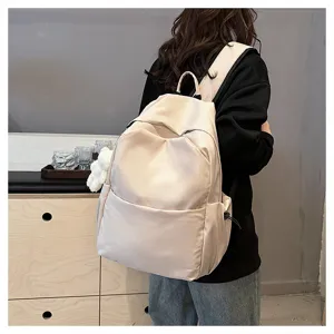 Detail view of minimalist beige casual backpack, large capacity school bag for daily use.