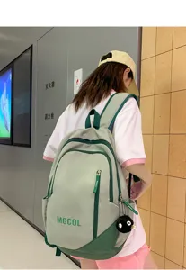 Large capacity student backpack in green, stylish school bag with multiple pockets for daily use.