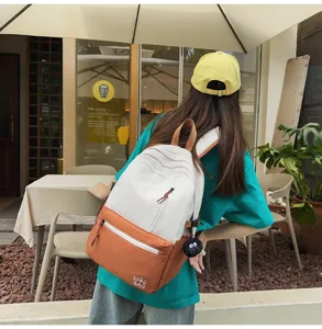 Stylish color-block canvas backpack for women and students, ideal for campus and daily use.