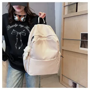 Casual solid color large capacity backpack for women and students with front pocket and cute charm.