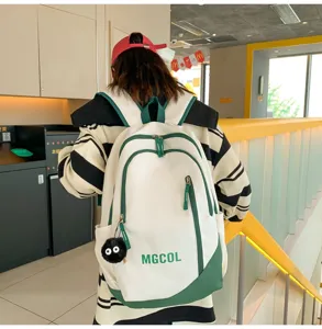 Large capacity student school bag, white and green canvas backpack with cute plush pendant.