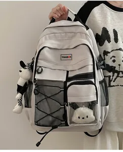 Detailed view of the utility school backpack showcasing multi-pockets and cute plush pendant.