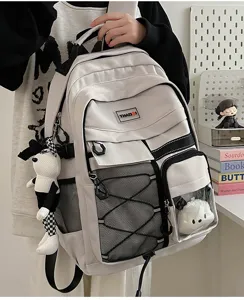 Close-up detail of the utility student backpack with mesh pockets and cute plush charms.