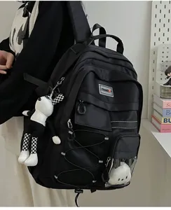 Casual multi-pocket canvas backpack for students, large capacity daily school bag with doll pendant.