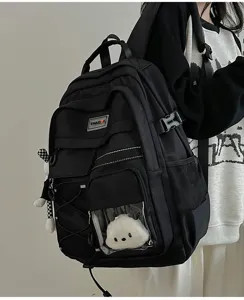 Utility style black school backpack detail showing clear front pocket and large storage.