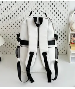 Detailed back view of casual white and black backpack, showing adjustable straps and hardware.